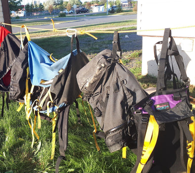 portage packs, canoe barrel harness drying in the sun