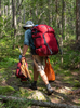  Man walking on a canoe trip portage 